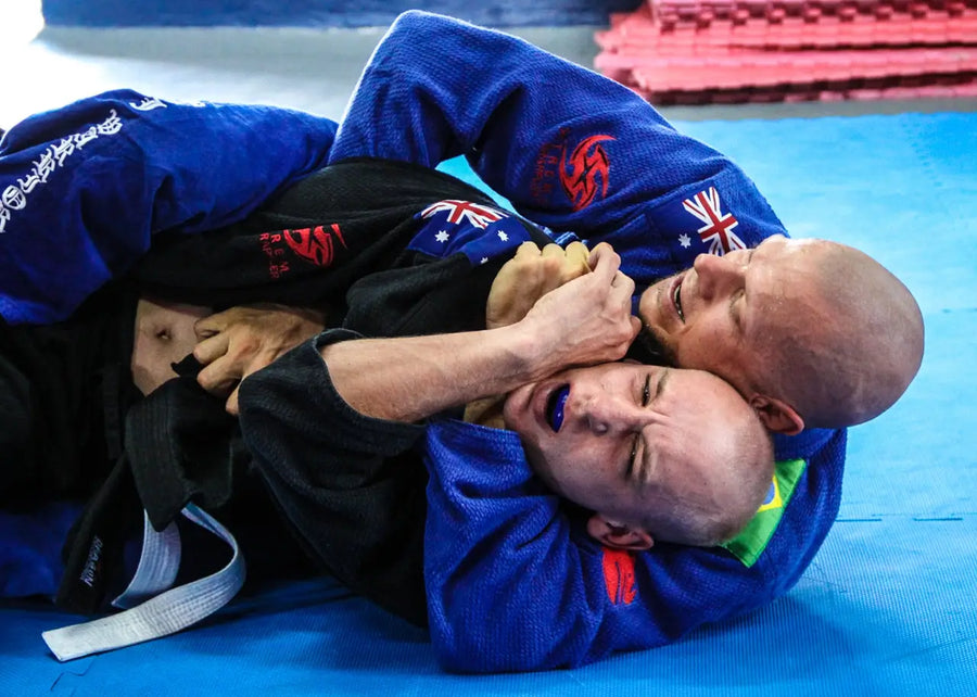Brazilian Jiu-Jitsu fighters grappling on a mat